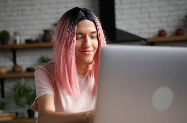 gender diverse person working on home office laptop